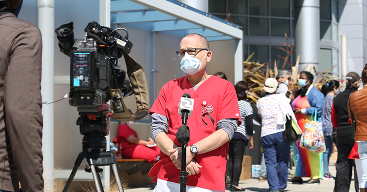 Nurse talking to press