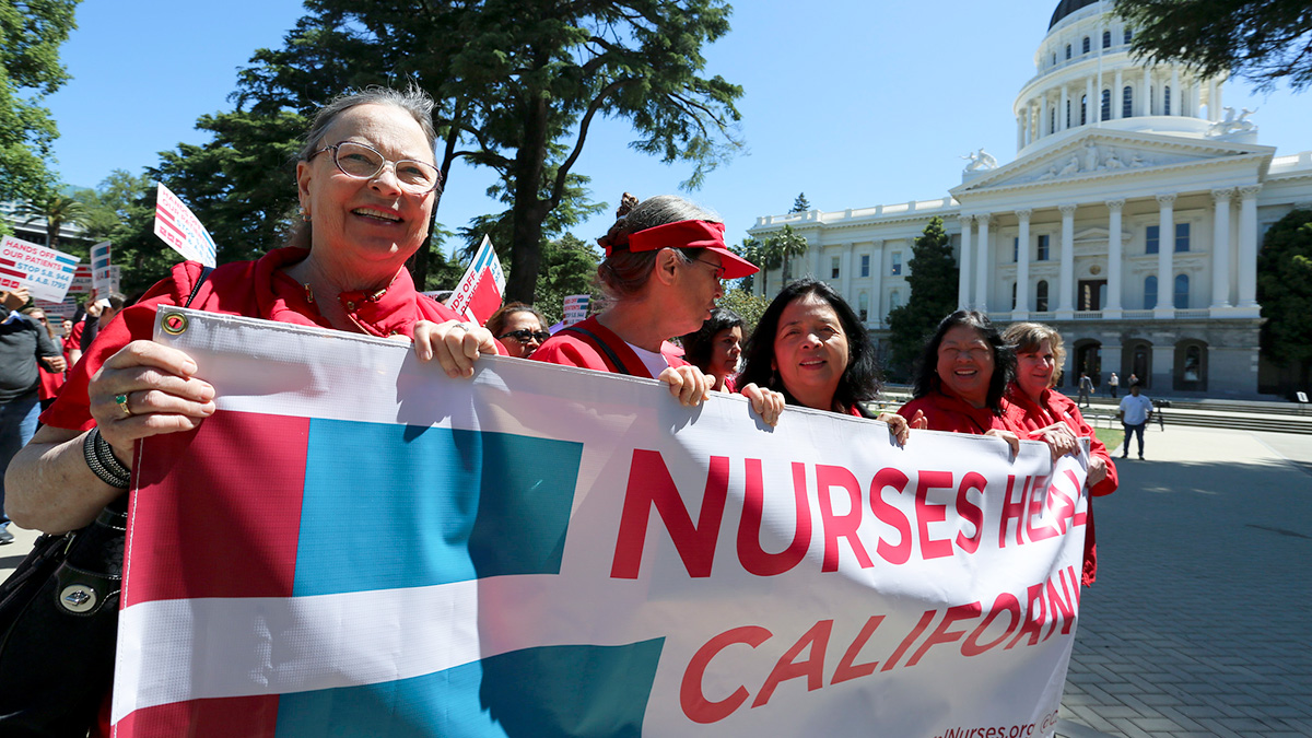 Group of CNA leaders hold banner "Nurses Heal California" outside state capitol