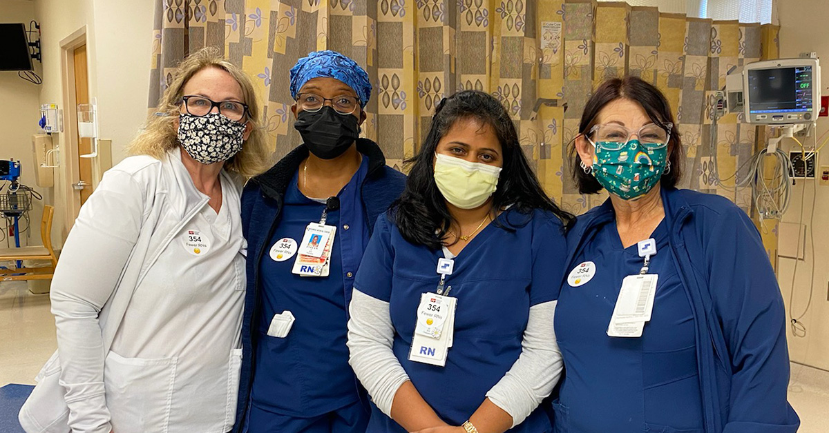 Group of four nurses inside hospital