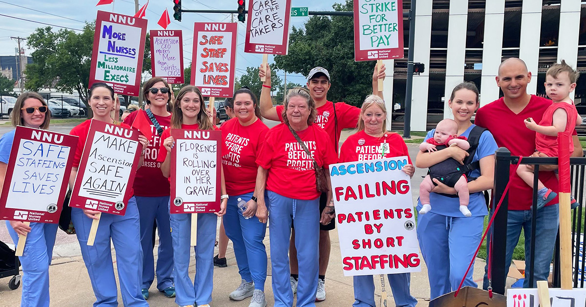 Large group of nurses outside hospitals holding various signs calling for nurse and patient safety