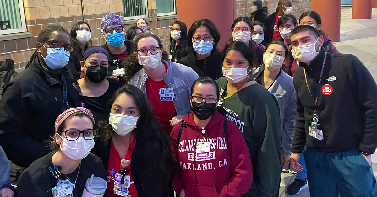 Large group of nurses and care givers outside hospital