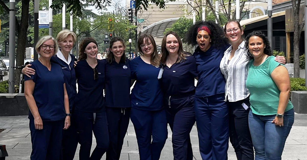 Group of nurses arm-in-arm outside