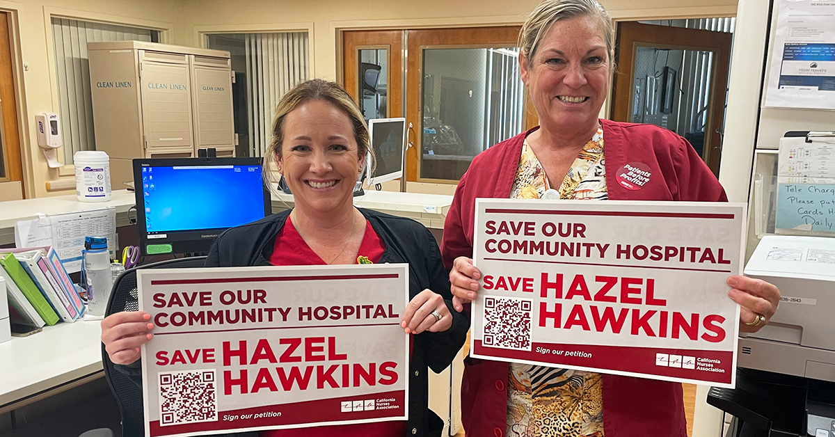 Nurses holding signs, "Save our community hospital, save Hazel Hawkins"