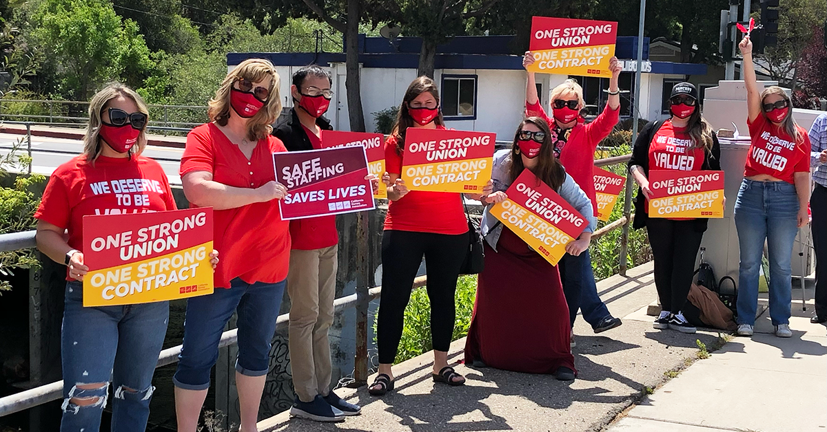 Sierra Vista nurses holding signs "One Strong Union. One Strong Contract" and "Safe Staffing Saves LIves"