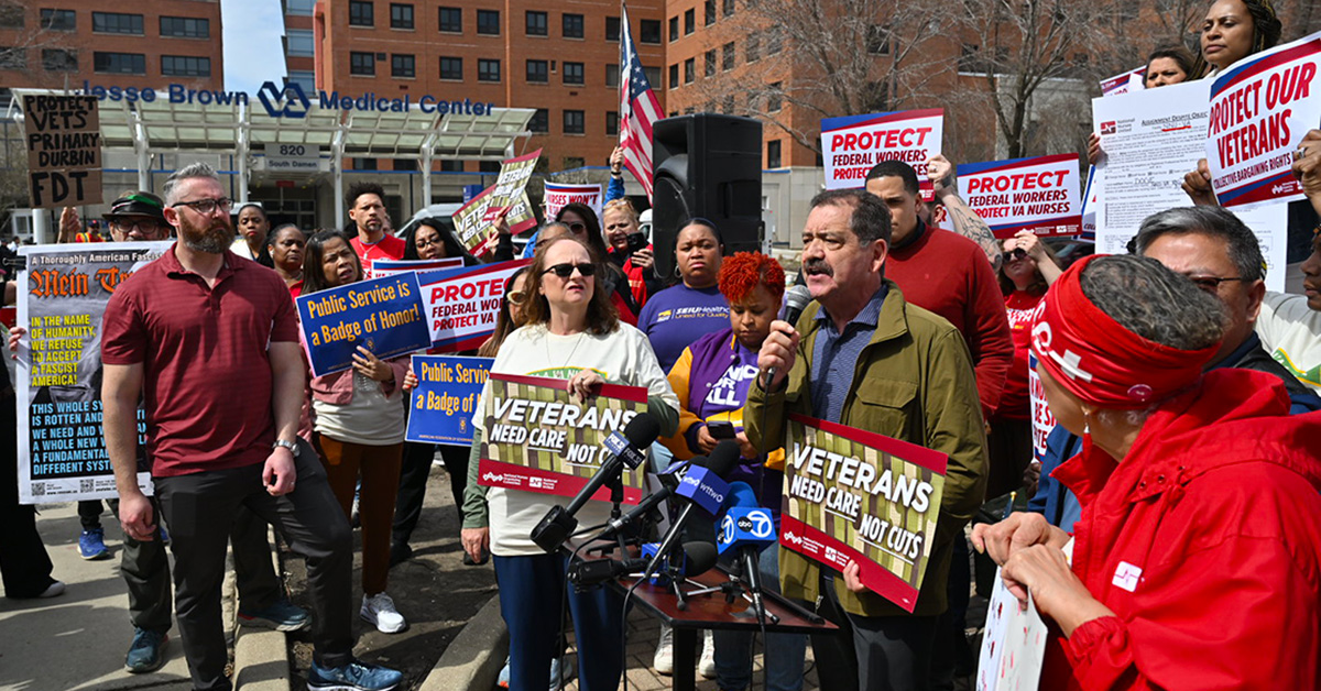 Health care workers and Congressman Chuy Garcia holding a press conference outside hospital