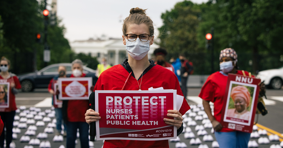 Nurses outside The White House hold signs "Protect Nurses, Patients, Public Health"