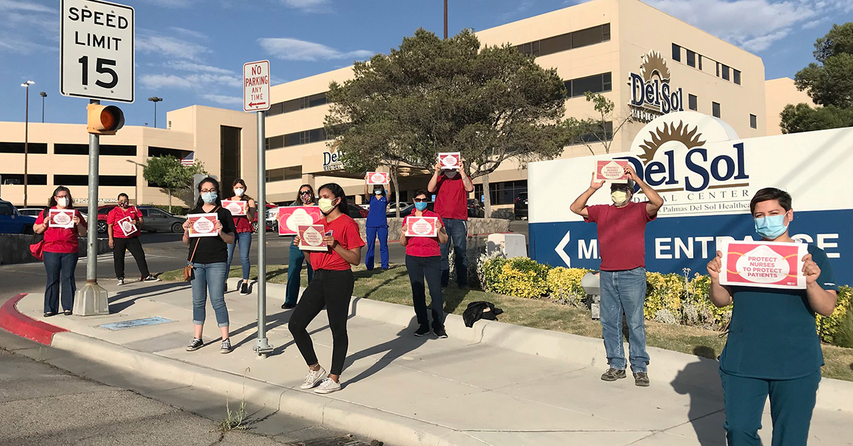 RNs outside hospital hold signs calling for safety measures