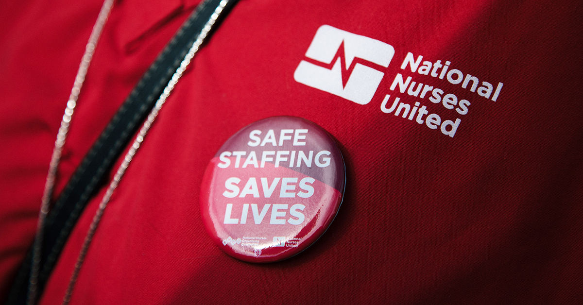 Button with "Safe Staffing Saves Lives" on scrub with "National Nurses United"