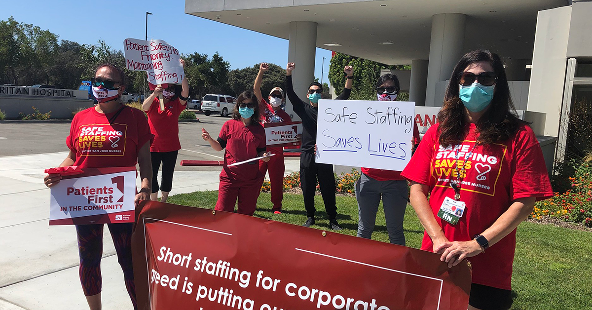 Nurses outside mission hospital hold signs calling for safe staffing