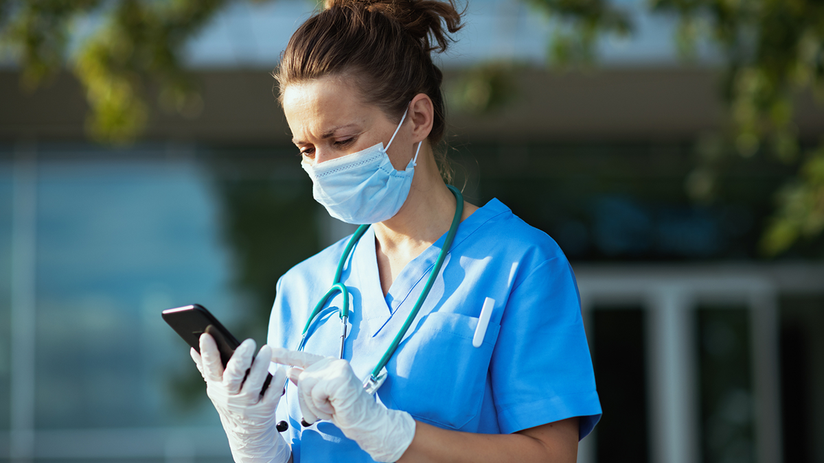 Nurse outside with smartphone