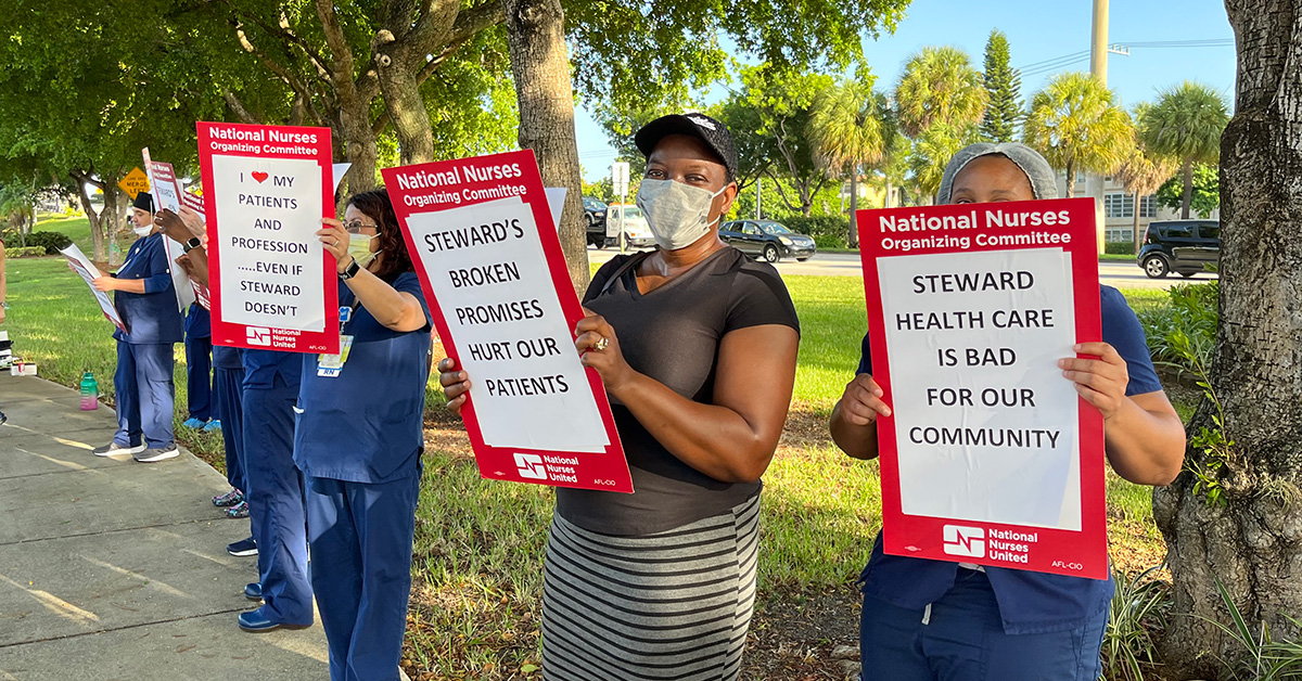 Nurses outside hold signs criticizing Steward Health's treatment of their patients