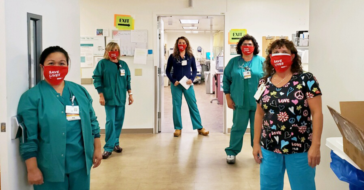 Five nurses in hospital hallway