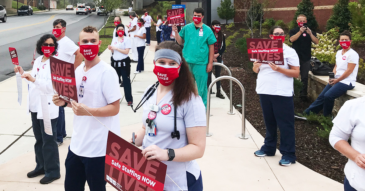 Nurses holding signs "Save Lives: Safe Staffing Now"