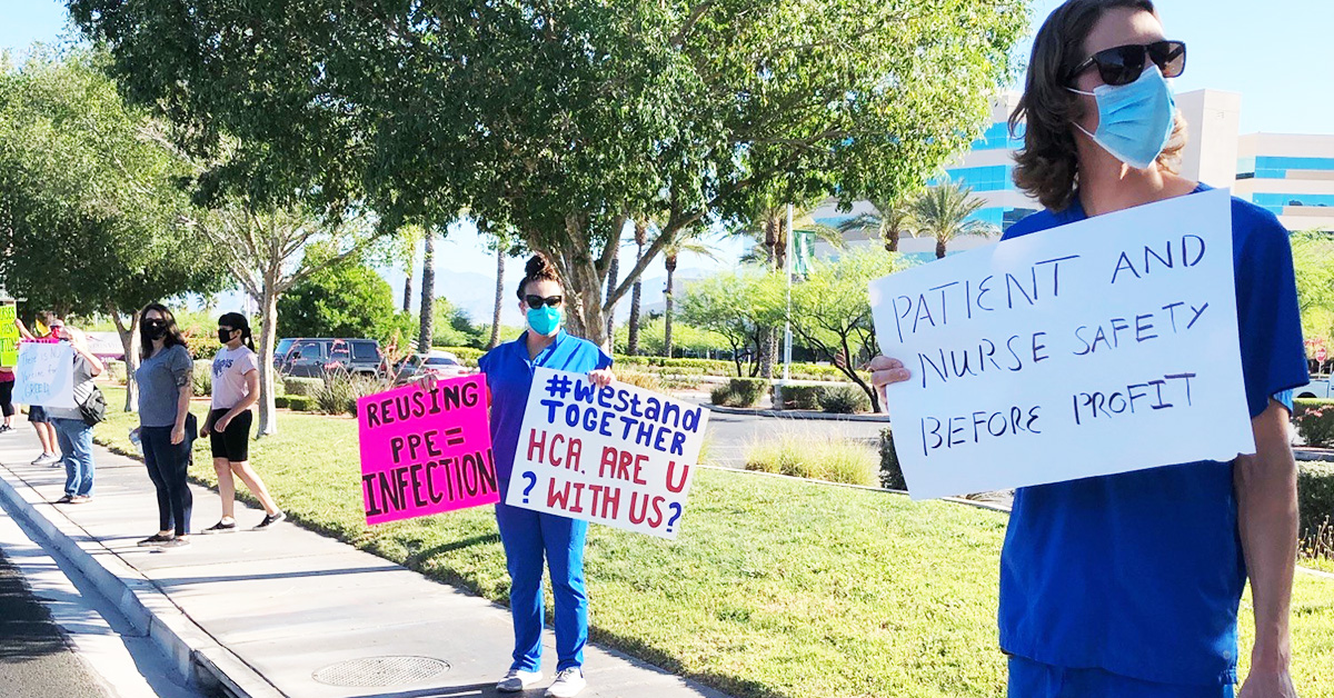 Nurses holding signs "Patient and nurse safety before profit", "We stand together, HCA are U with us?", "Reusing PPE = Infection"