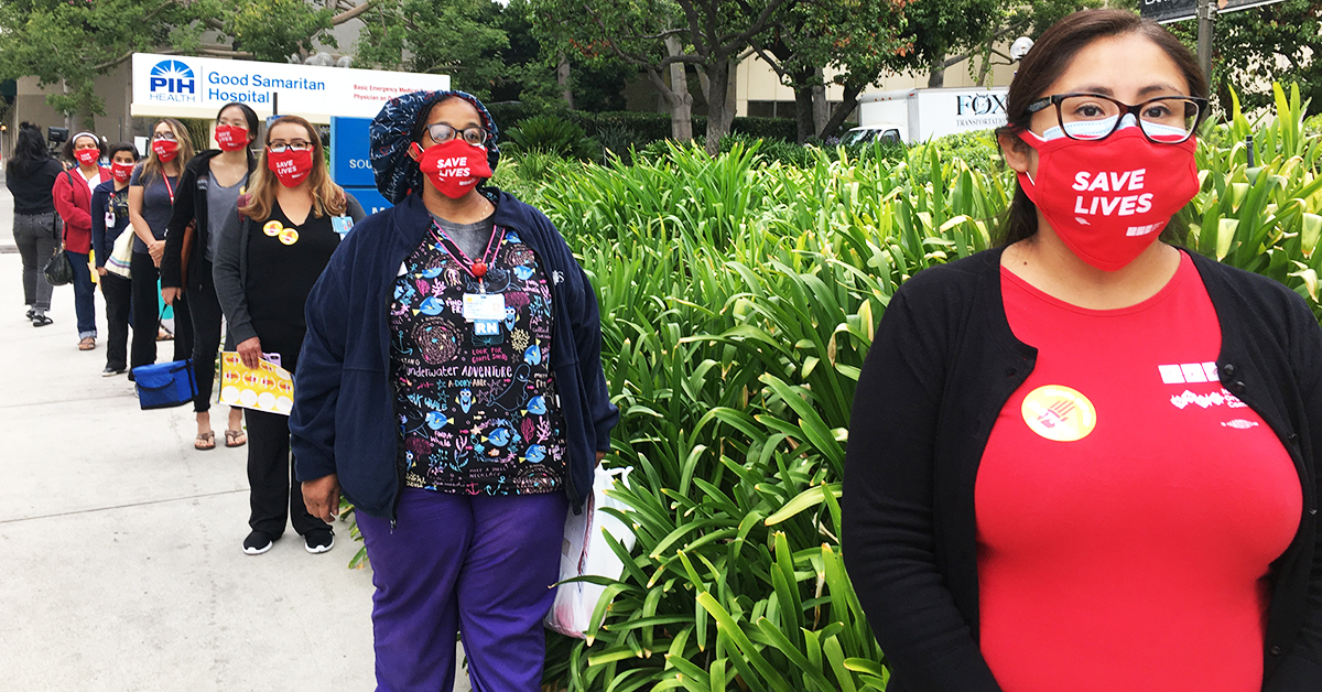 Nurses in front of Good Samaritan Hospital sign with masks "Save lives"