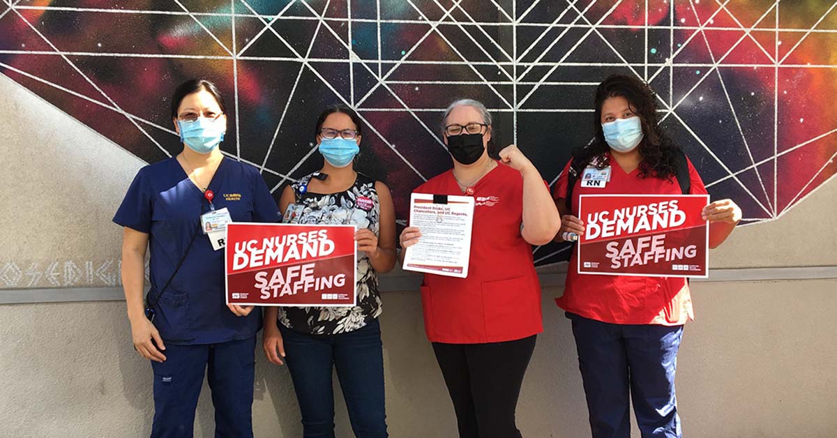 Davis nurses outside holding signs "UC Nurses Demand Safe Staffing"