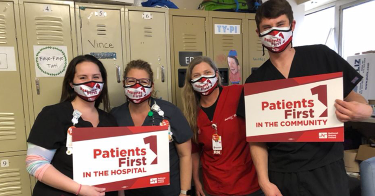 Four nurses inside hospital hold signs "Patients First"