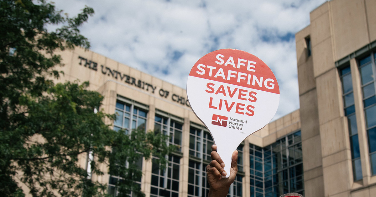 Hand holding sign "Safe Staffing Saves Lives"