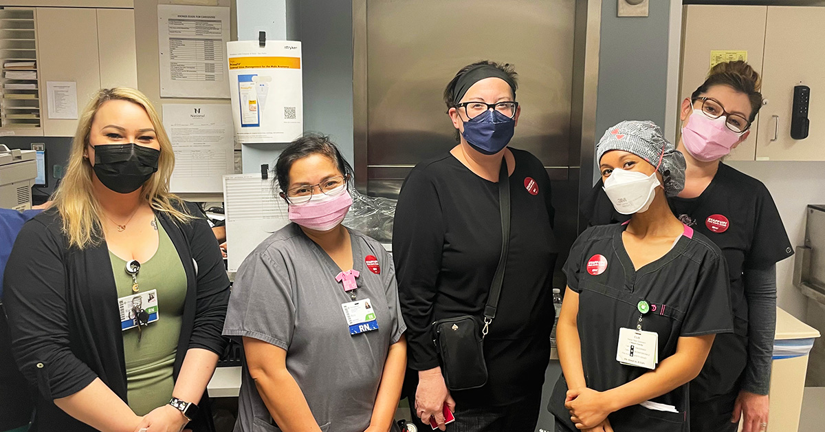 Group of five nurses inside hospital