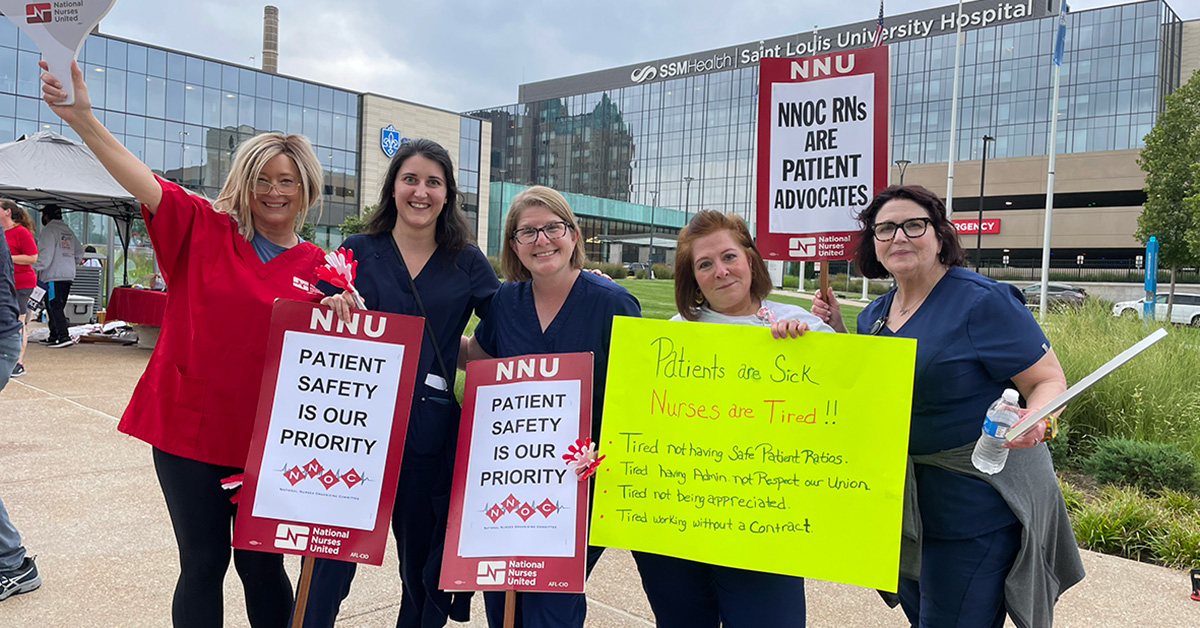 Group of five nurses outside Saint Louis University Hospital holding signs calling for patient safety