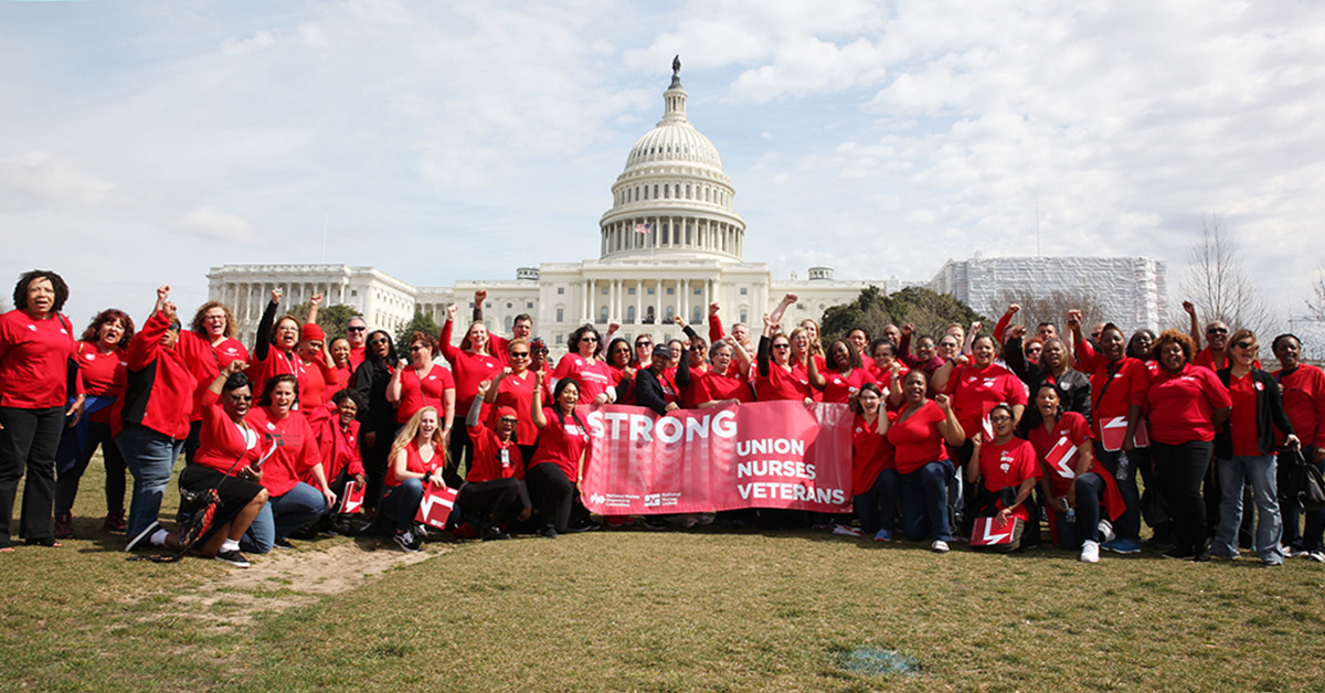 Large group of nurses outside Capitol building holding banner "Strong Union, Nurses, Veterans"