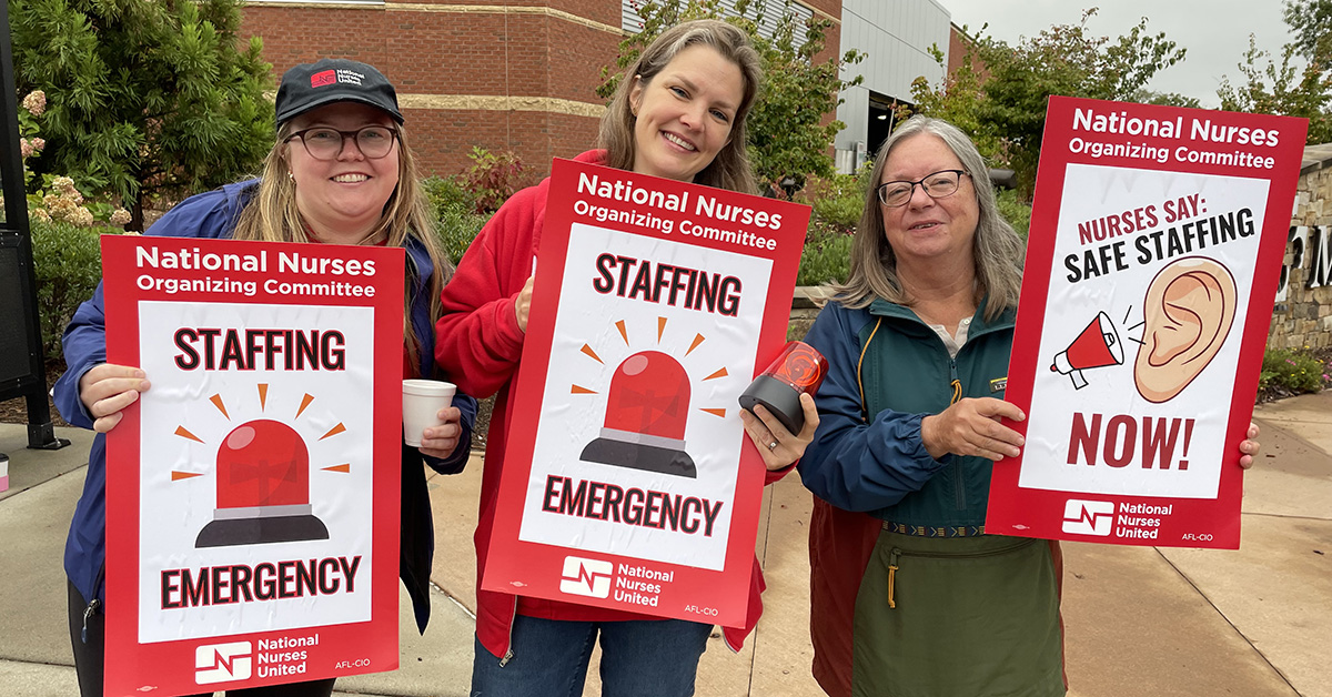Asheville nurses hold signs that read "Staffing Emergency"