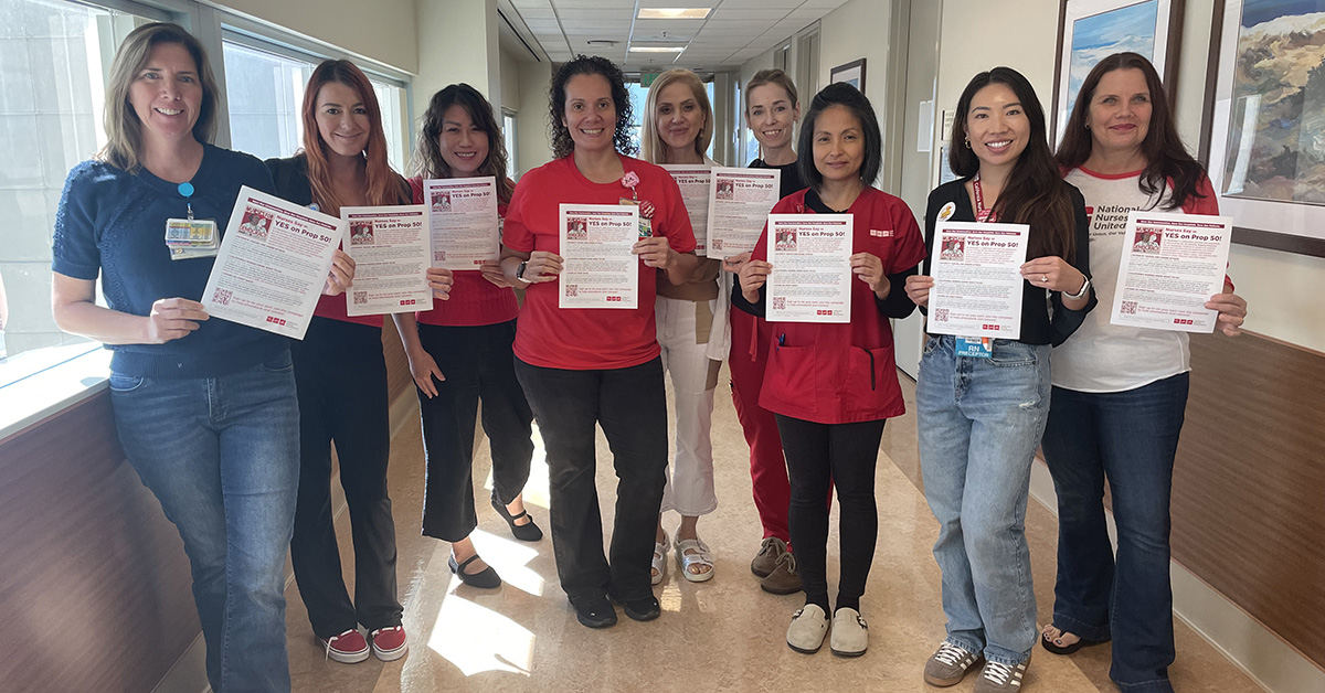 San Diego nurses hold flyers in support of prop. 50
