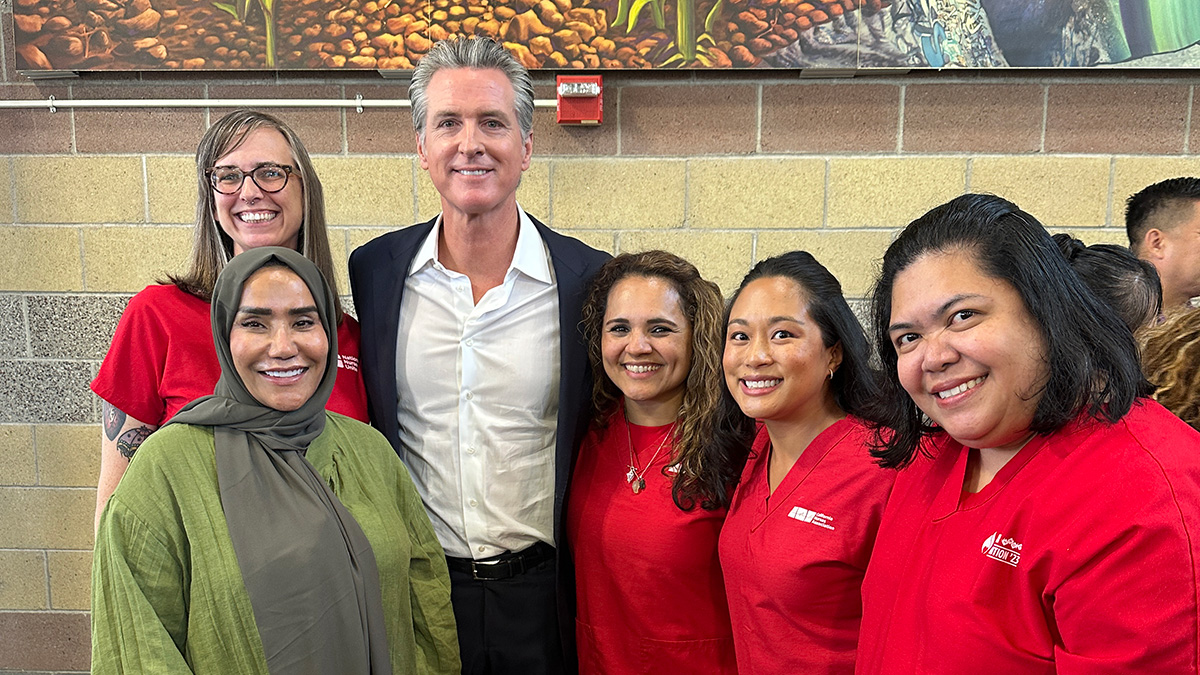 Five nurses standing with Governor Gavin Newsom