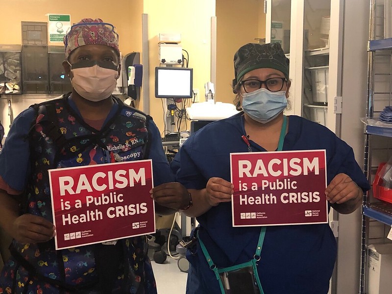 nurses holding signs