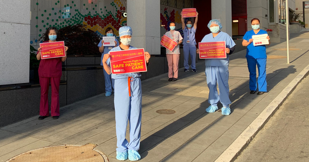 Nurses in front of Chinese Hospital with signs "Nurses fight for safe patient care"