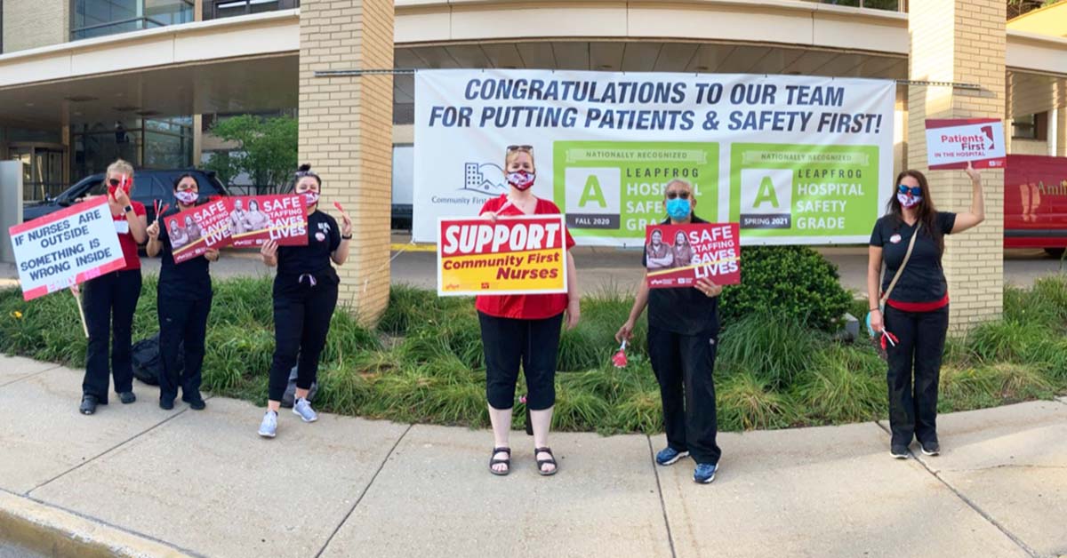 Nurses outside Community First Medical Center hold signs calling for safety