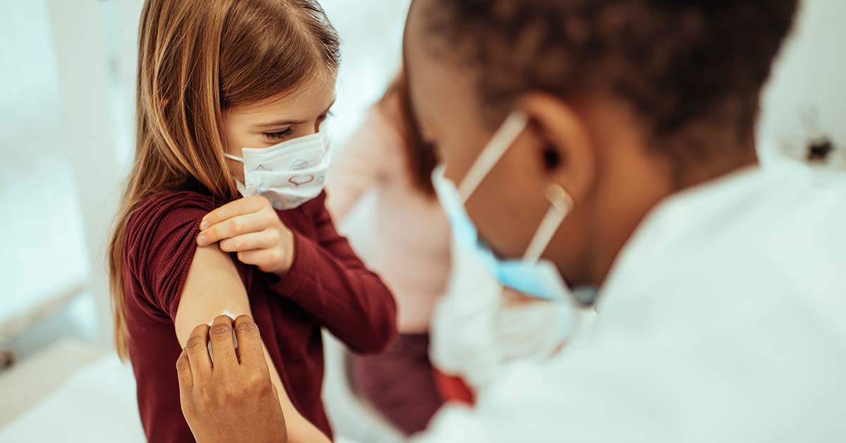 Nurse prepparing child for vaccine