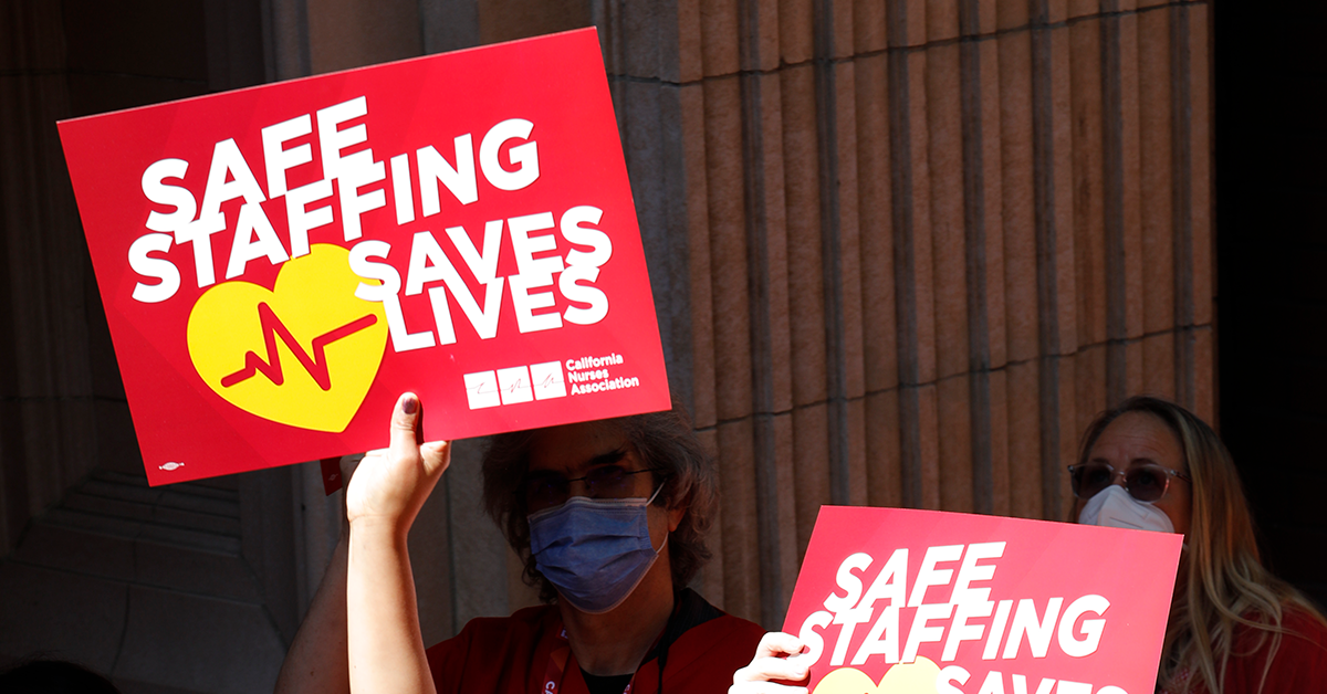 Nurses holding signs that read "Safe staffing Saves Lives"