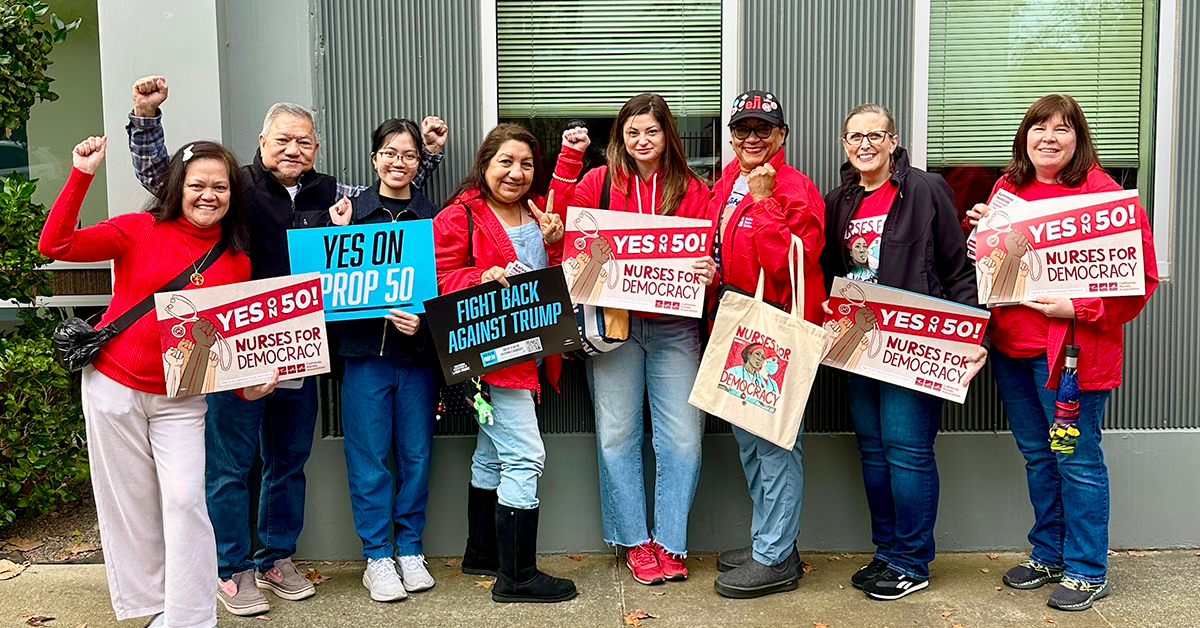 Nurses holding signs "Yes on 50: Nurses for Democracy"