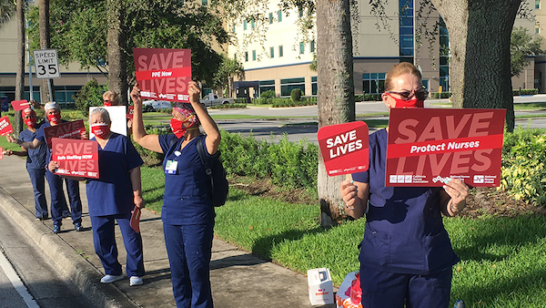 Nurses hold signs calling for hospital safety