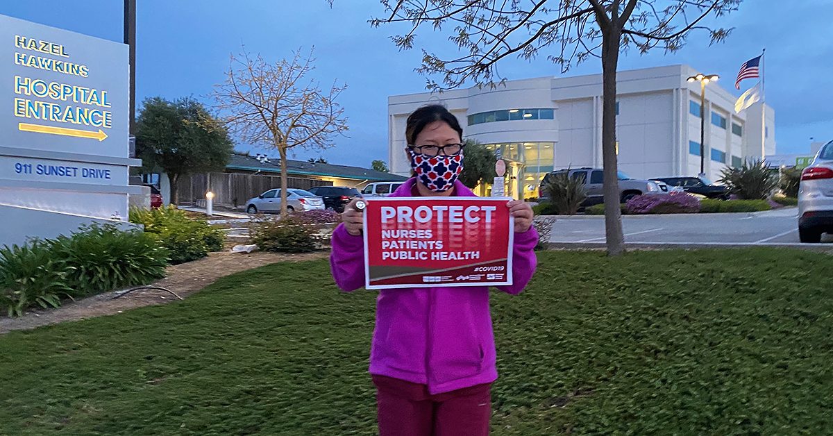 Nurse in front of Hazel Hawkins with sign "Protect Nurses, Patients, Public Health"