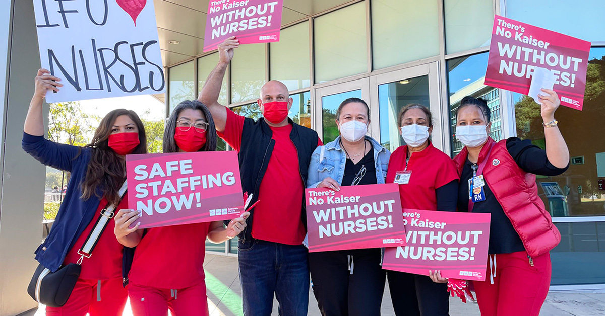 Kaiser nurses holding signs "Safe staffing now!" and "There's no Kaiser without nurses!"