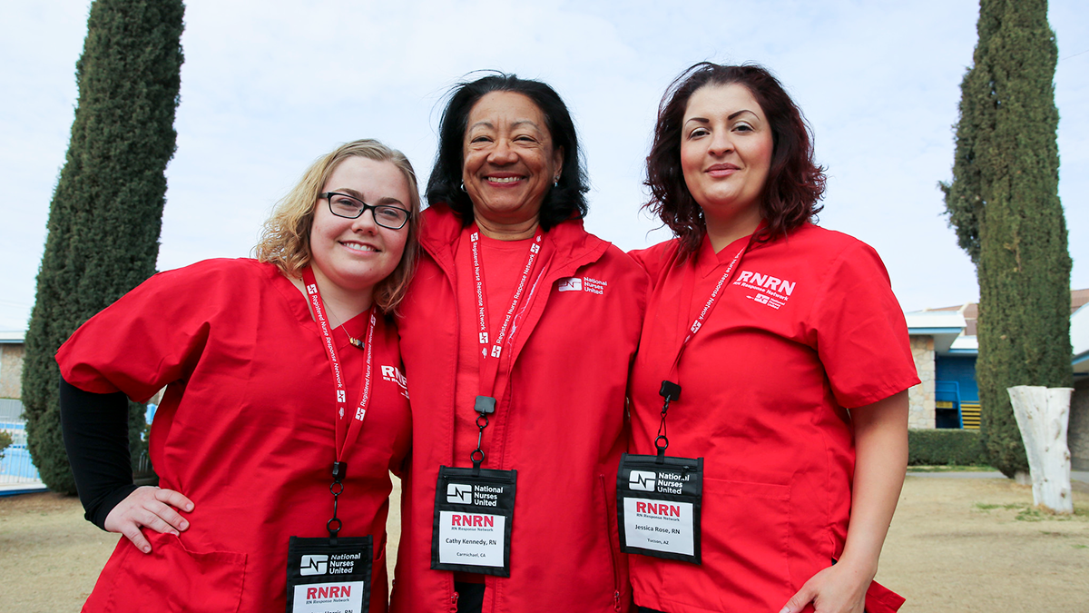 Three RNRN nurses standing together smiling