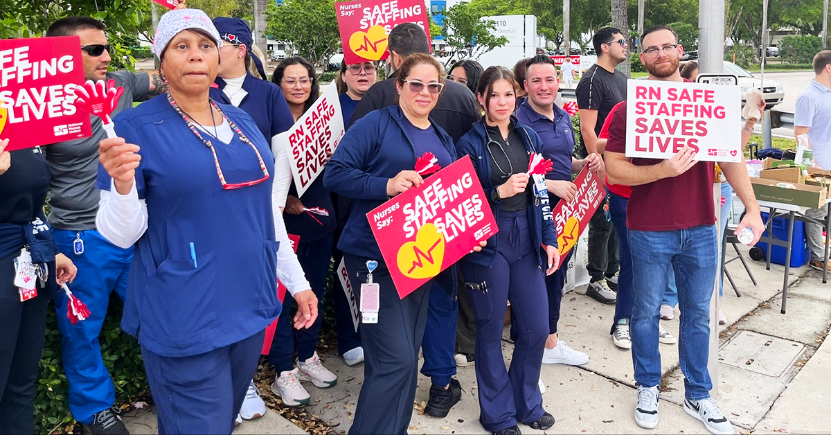 Palmetto RNs holding signs "Safe staffing saves lives" and "RN safe staffing saves lives"