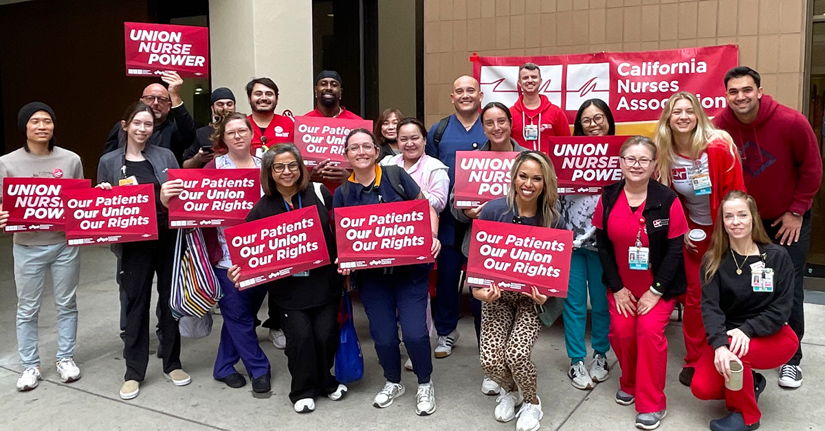 Group of nurses holding signs "Our Patients, Our Union, Our Rights"