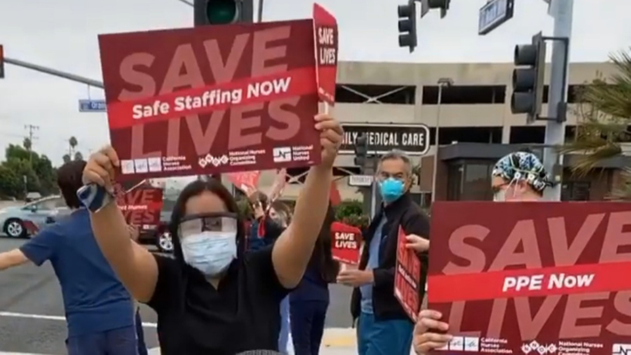 Nurses hold signs calling for safe staffing