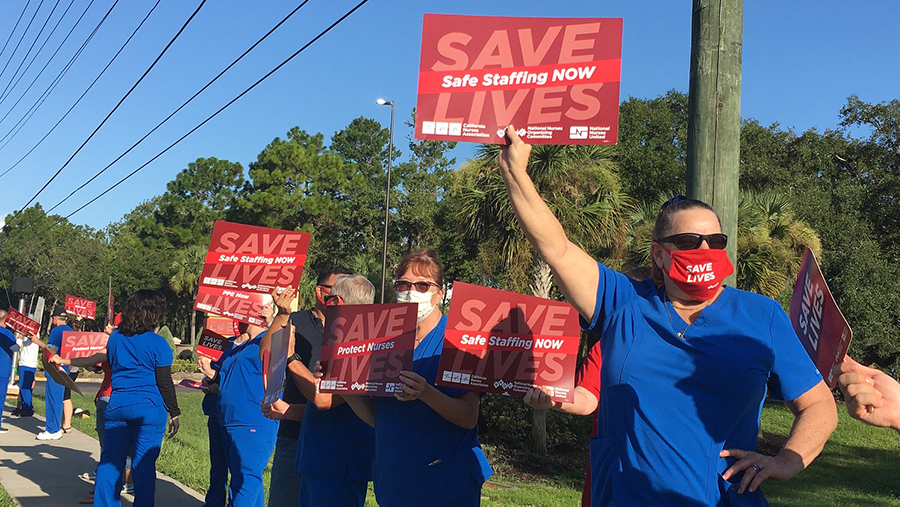 Nurses hold signs calling for safe staffing