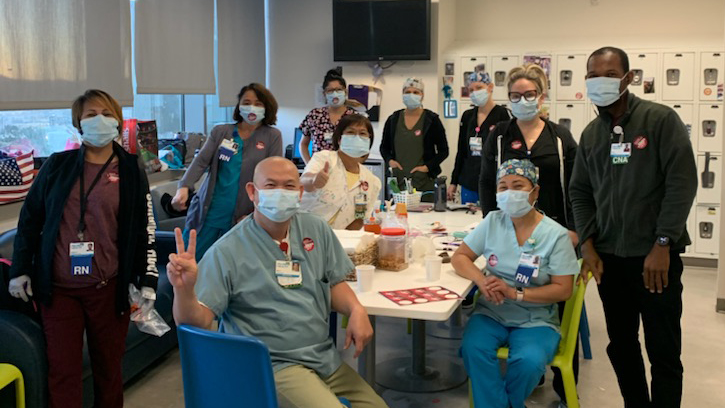 Palomar Health healthcare workers inside hospital wear stickers calling for safe staffing ratios