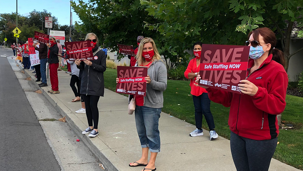 Nurses holds signs for safe staffing