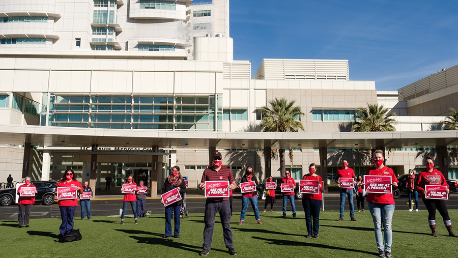 Nurses outside UC Davis Medical Center hold signs calling for safety measures