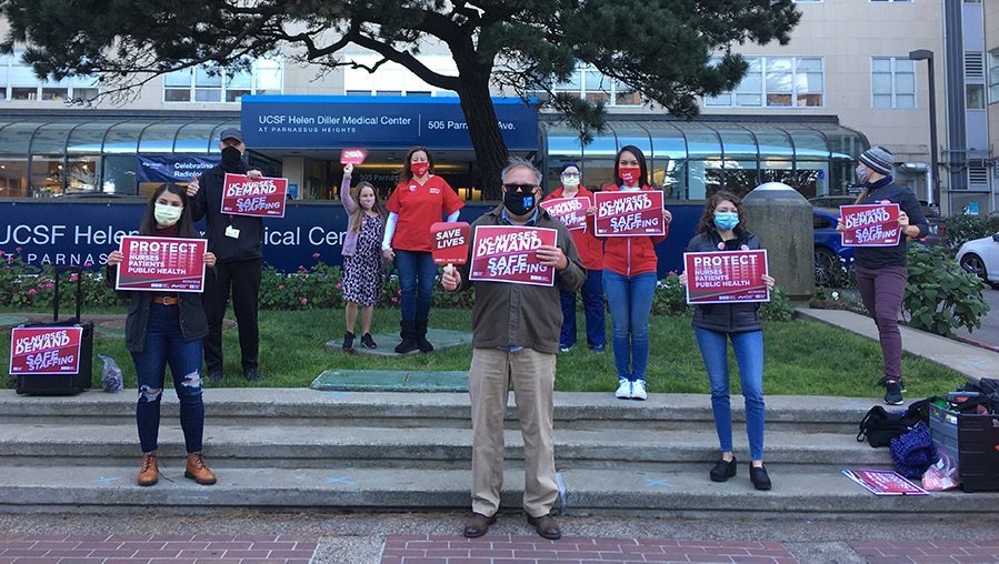 Nurses outside UCSF hospital hold signs calling for safe staffing