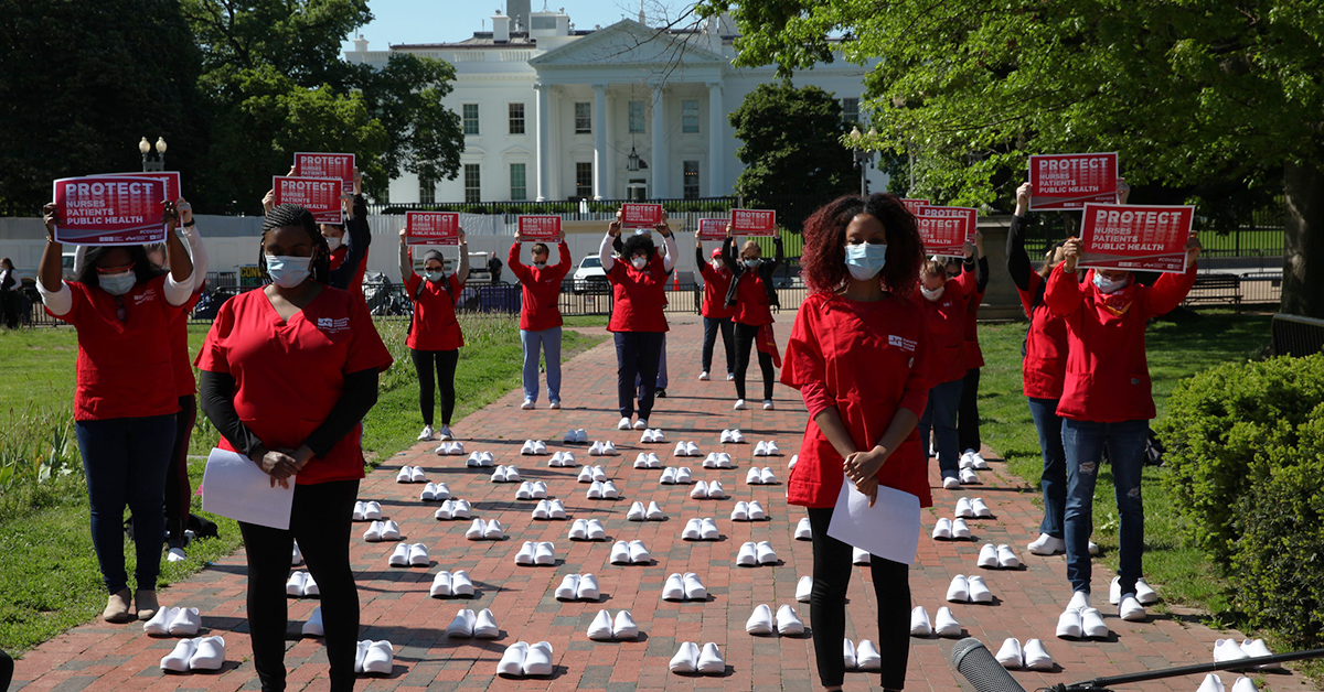 Nurses outside The White House holding signs calling for nurse, patient, and public safety