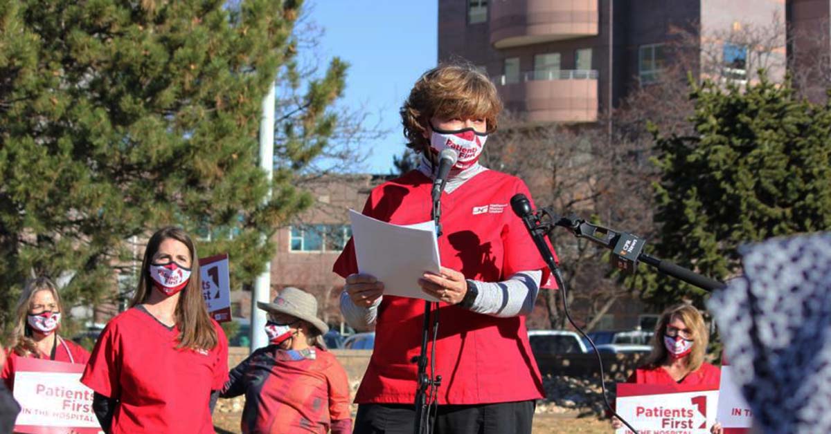 Nurses stand and speak in front of news crew