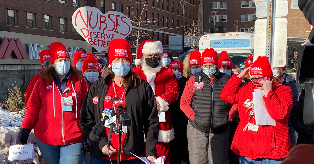 Group of nurses giving press conference with Santa