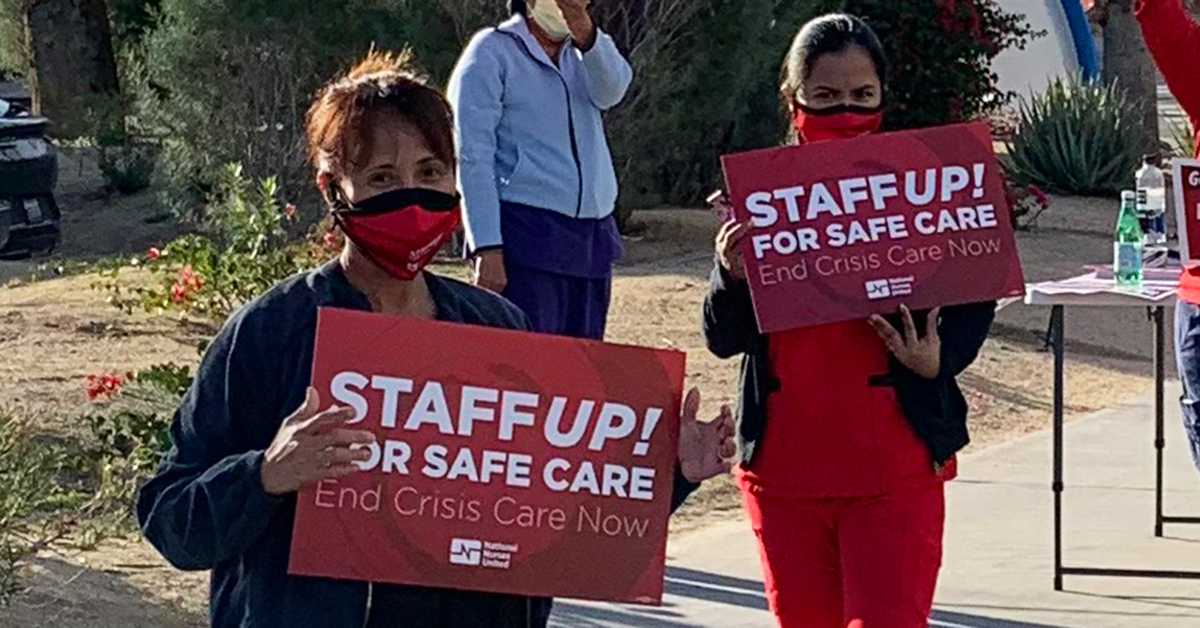 Nurses holding signs "Staff UP for safe care. End Crisis Care Now"